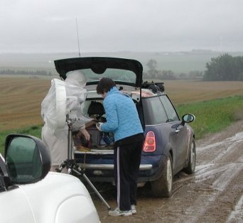 See the wet gravel. The rain is just starting. Their rig is bagged.